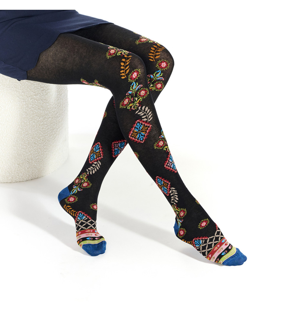Collants noirs avec des motifs géométriques colorés et des plantes remontant jusqu’aux cuisses.