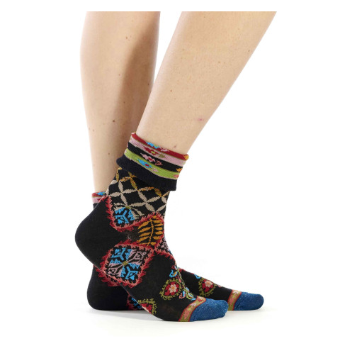 Chaussettes noires de la marque Dub & Drino avec motifs géométriques et floraux, bord-côte à revers.